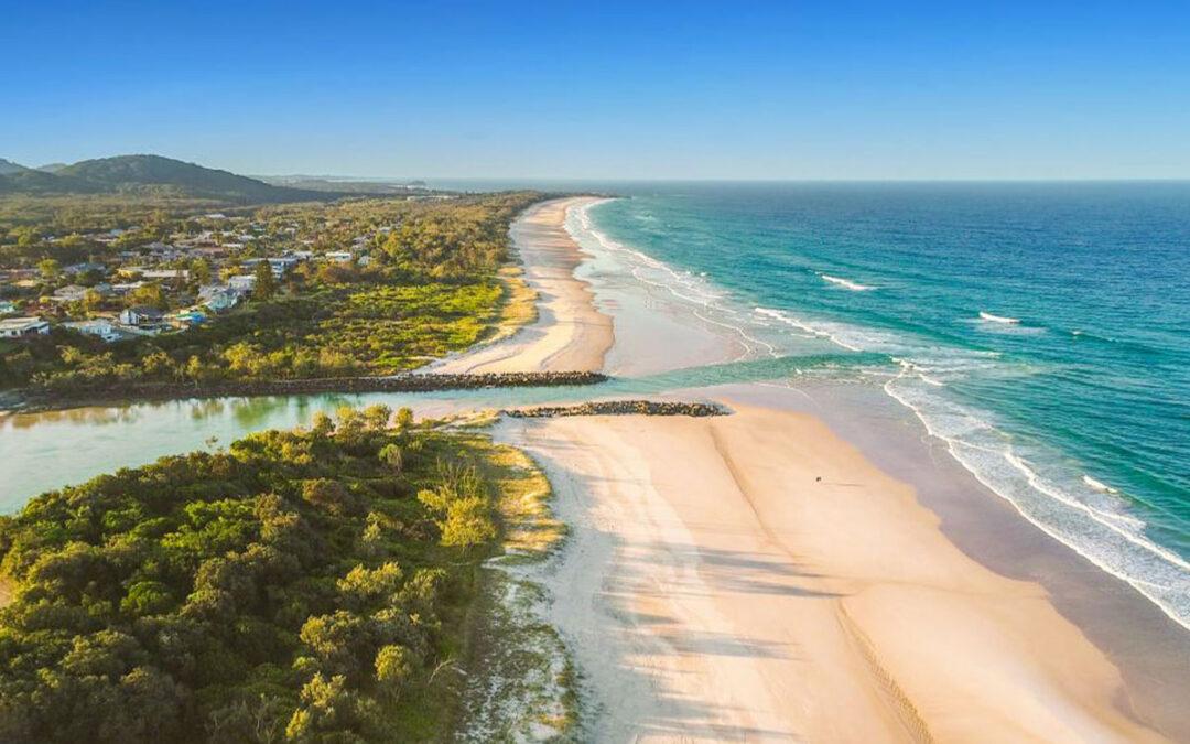 Elevated drone photo of the Tweed Shire coastline overlooking the mouth of a river meeting the sea